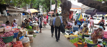 People walking around a street market in Ghana.